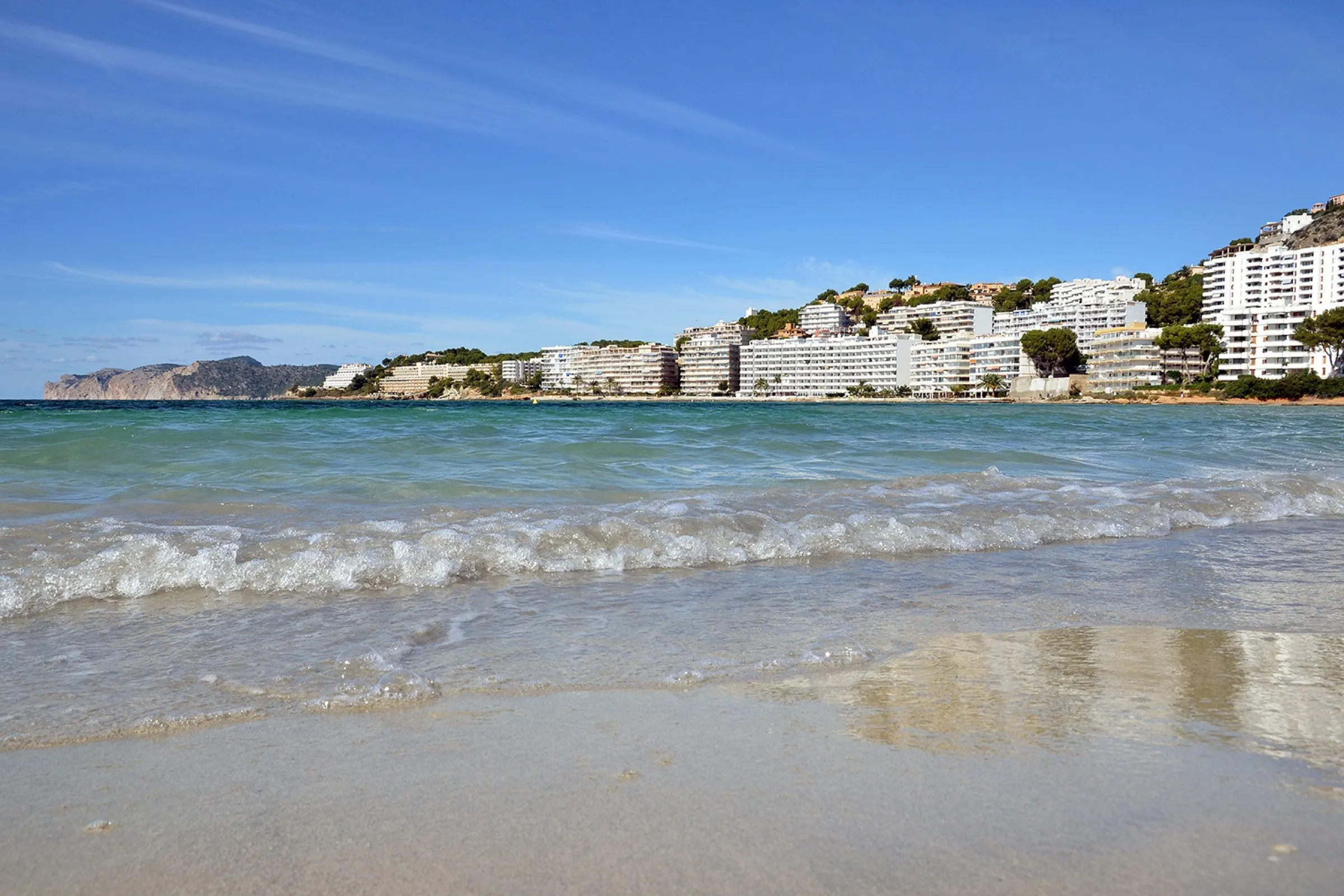 The water's edge at Santa Ponça beach, with clear water and the town's hotels behind