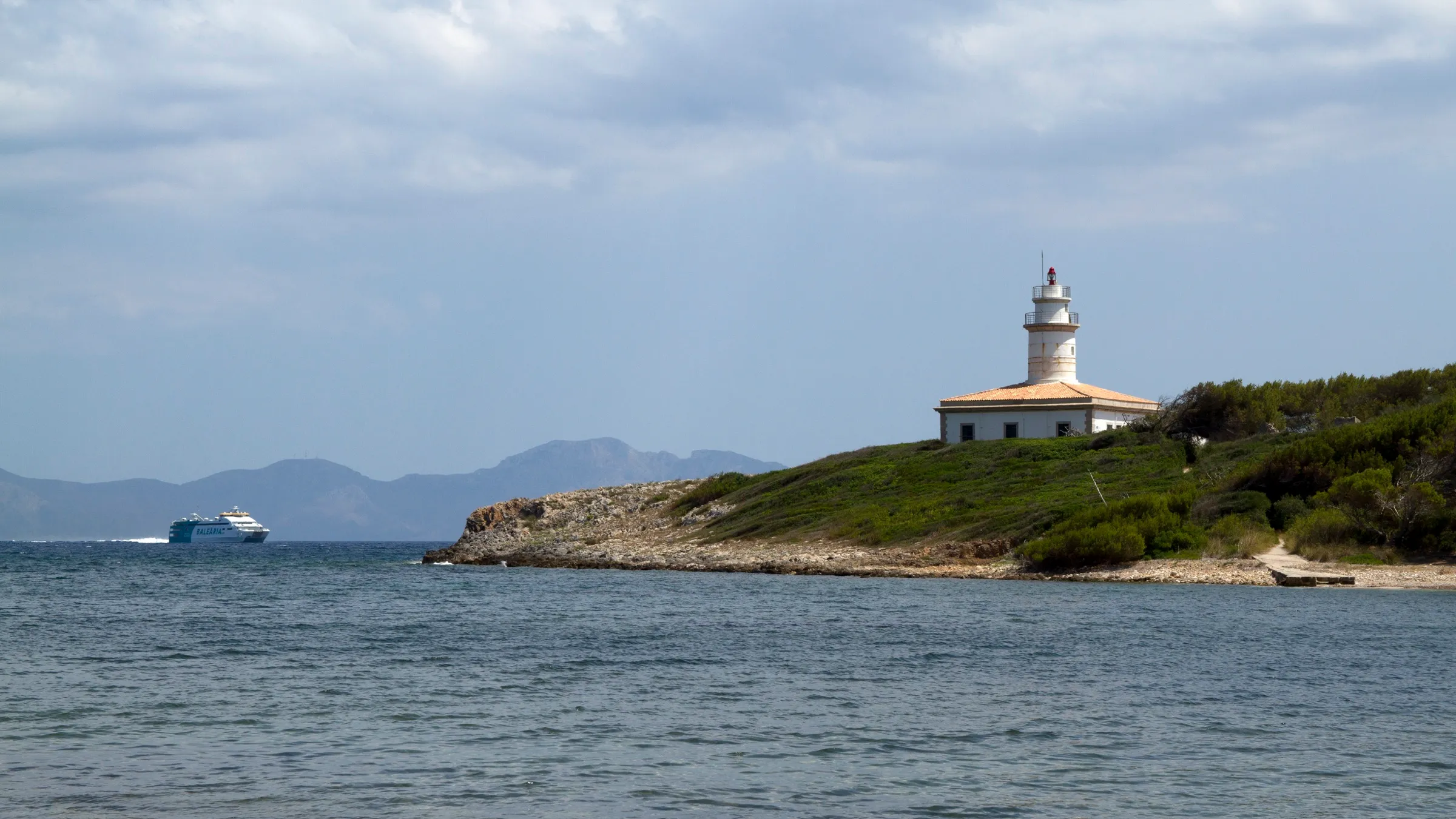 Die Insel Alcanada mit ihrem Leuchtturm, von der Küste aus gesehen
