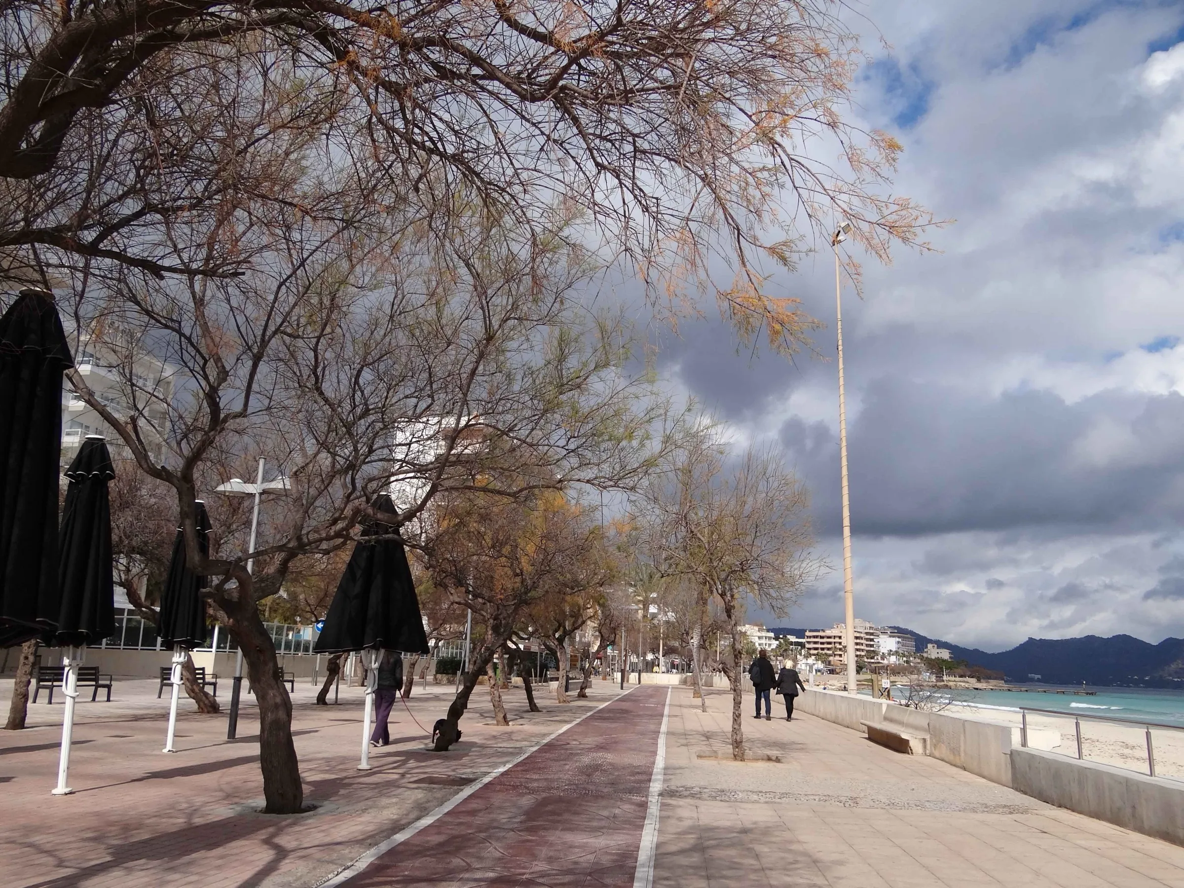 The Cala Millor seafront promenade in winter, with the cycle lane and the beach on the right